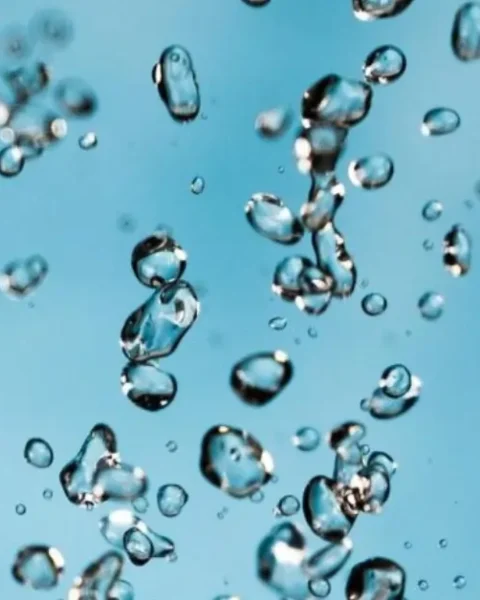 Close-up of suspended water droplets representing water-based adhesive dispersion.