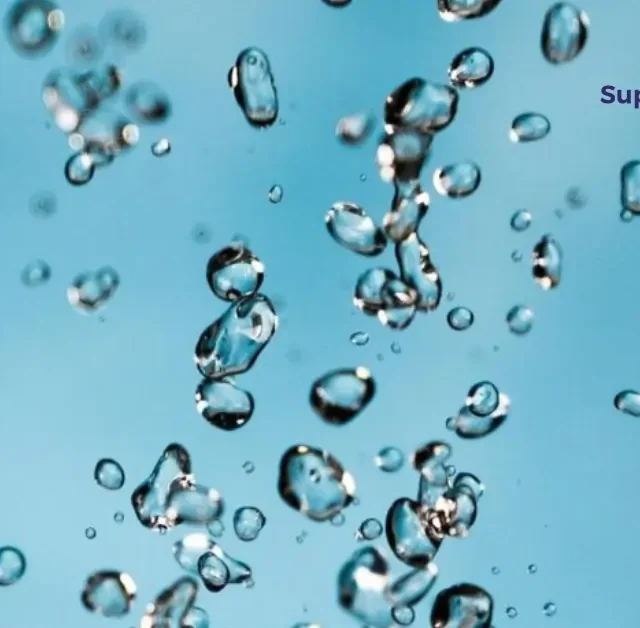Close-up of suspended water droplets representing water-based adhesive dispersion.