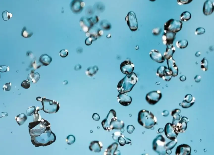 Close-up of suspended water droplets representing water-based adhesive dispersion.
