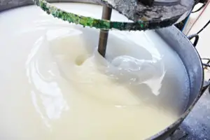 Industrial mixing of thick water-based adhesive in a large container